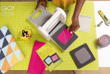 Load image into Gallery viewer, AccuQuilt Go! Me Fabric Cutter Starter Set, 5 Patterns with Instructions, 6 x 6 Inch Cutting Mat, and 2 Dies