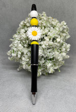 Load image into Gallery viewer, Pen with a daisy design on top of white flowers against a gray background