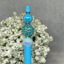 Load image into Gallery viewer, Blue decorative hair stick with beads on a floral background