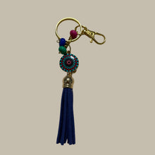 Load image into Gallery viewer, Handmade gold keyring with a blue enamel charm, tassel, and beads.