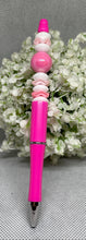 Load image into Gallery viewer, Pink pen with decorative beads on a gray background with white flowers.