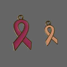 Load image into Gallery viewer, Two pink ribbon charms on a textured beige background