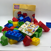 Load image into Gallery viewer, A collection of Mega Bloks Miniblocks in various colors spilling out of a yellow tote bag with a sticker on it. The set is labeled as '7104 Miniblocks Tote' and appears to be a used item.