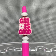 Load image into Gallery viewer, Pink pen with &#39;GOD IS GOOD&#39; text on a clear stand against a gray background
