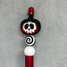 Load image into Gallery viewer, Decorative pen top with black, white, and red design on a textured gray background
