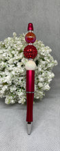 Load image into Gallery viewer, Decorative pen with red and brown beads on a gray background
