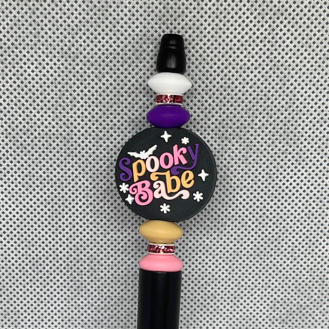 Beadable Pen with 'Spooky Babe' text on a textured gray background