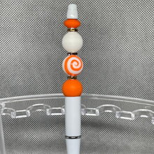 Load image into Gallery viewer, Decorative pen with orange and white beads on a metallic surface
