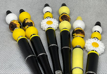 Load image into Gallery viewer, Set of pens with decorative ends on a textured gray background
