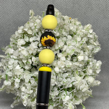 Load image into Gallery viewer, Pen with sunflower design and yellow beads on a white floral background
