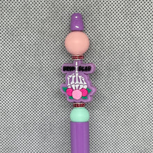 Load image into Gallery viewer, Decorative pen with a skeleton design and pink accents on a textured gray background
