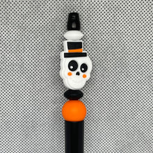 Load image into Gallery viewer, Halloween-themed decorative pen with a skull design on a textured gray background
