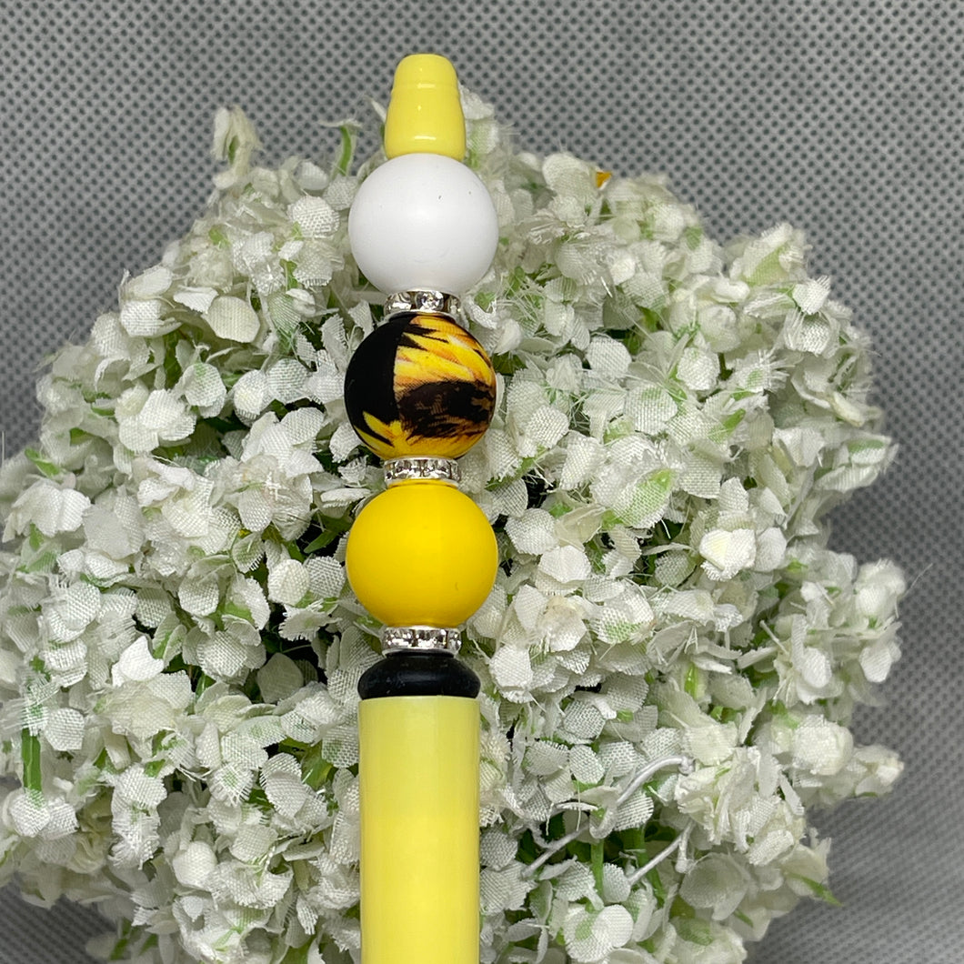 Decorative object with yellow and black beads on a floral background