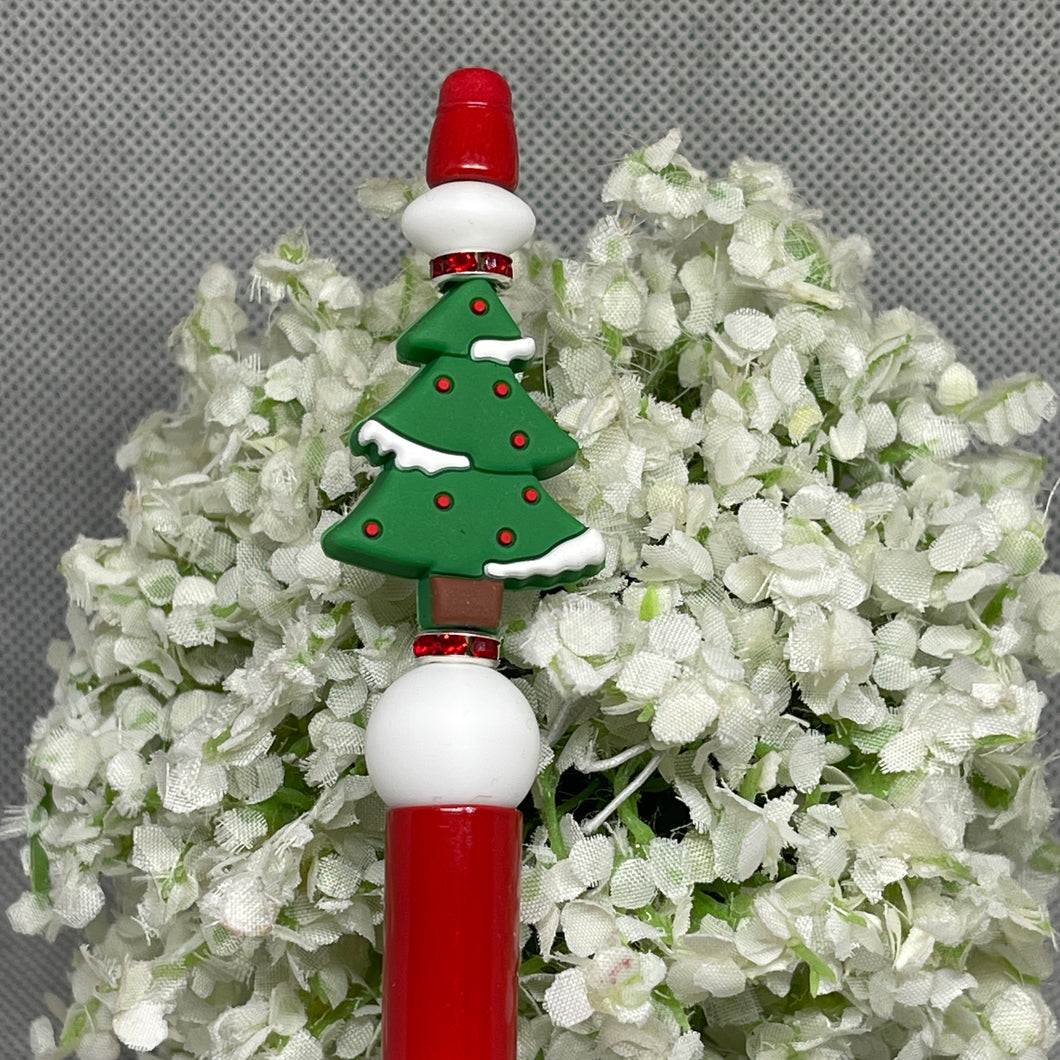 Decorative pen with Christmas tree design on a floral background
