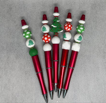 Load image into Gallery viewer, Set of red pens with decorative beads on a textured surface
