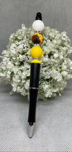 Load image into Gallery viewer, Pen with decorative top on a white floral background
