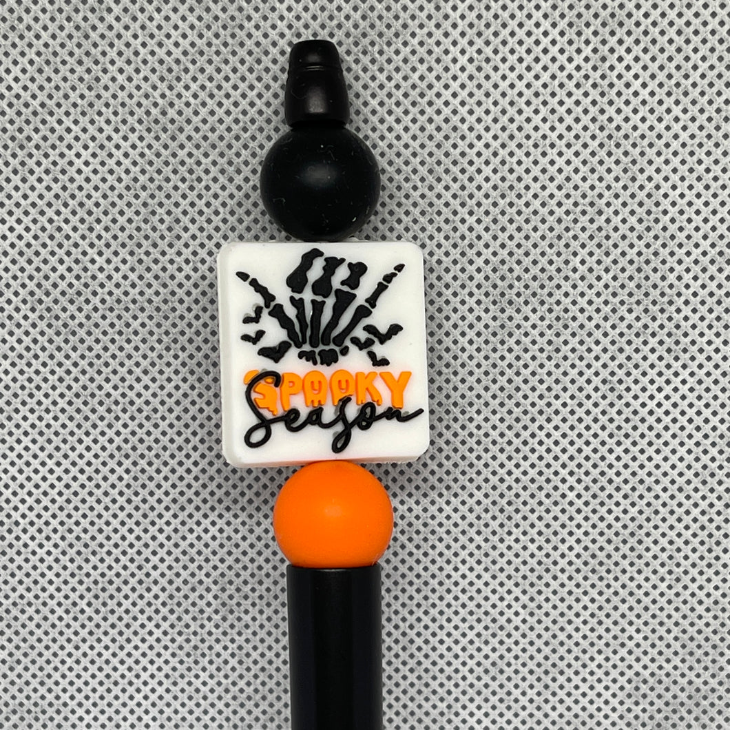 Halloween-themed beadable pen with 'Spooky Season' text on a textured gray background