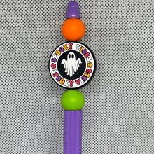 Load image into Gallery viewer, Halloween-themed beadable  pen with colorful beads and a ghost design on a textured background
