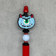 Load image into Gallery viewer, Beadable Pen with a cartoonish monster design on a textured gray background
