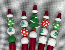 Load image into Gallery viewer, Decorative Christmas-themed beads on a textured gray background
