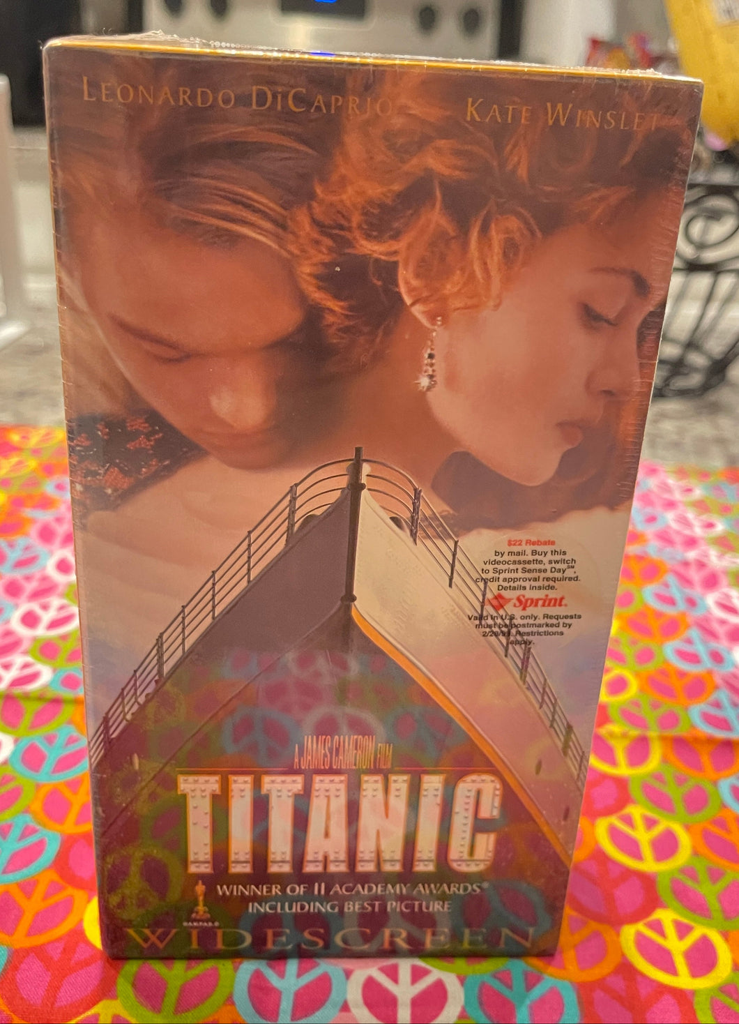 VHS tape of 'Titanic' with a colorful tablecloth underneath