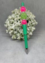 Load image into Gallery viewer, Green pen with colorful beads on a white floral background

