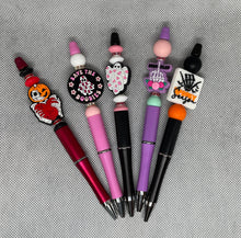 Load image into Gallery viewer, Set of colorful pens with unique designs on a textured surface
