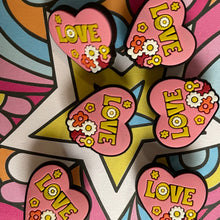 Load image into Gallery viewer, Colorful heart-shaped 'LOVE' stickers on a vibrant, abstract background

