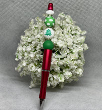 Load image into Gallery viewer, Red pen with green and white bead decorations on a gray background
