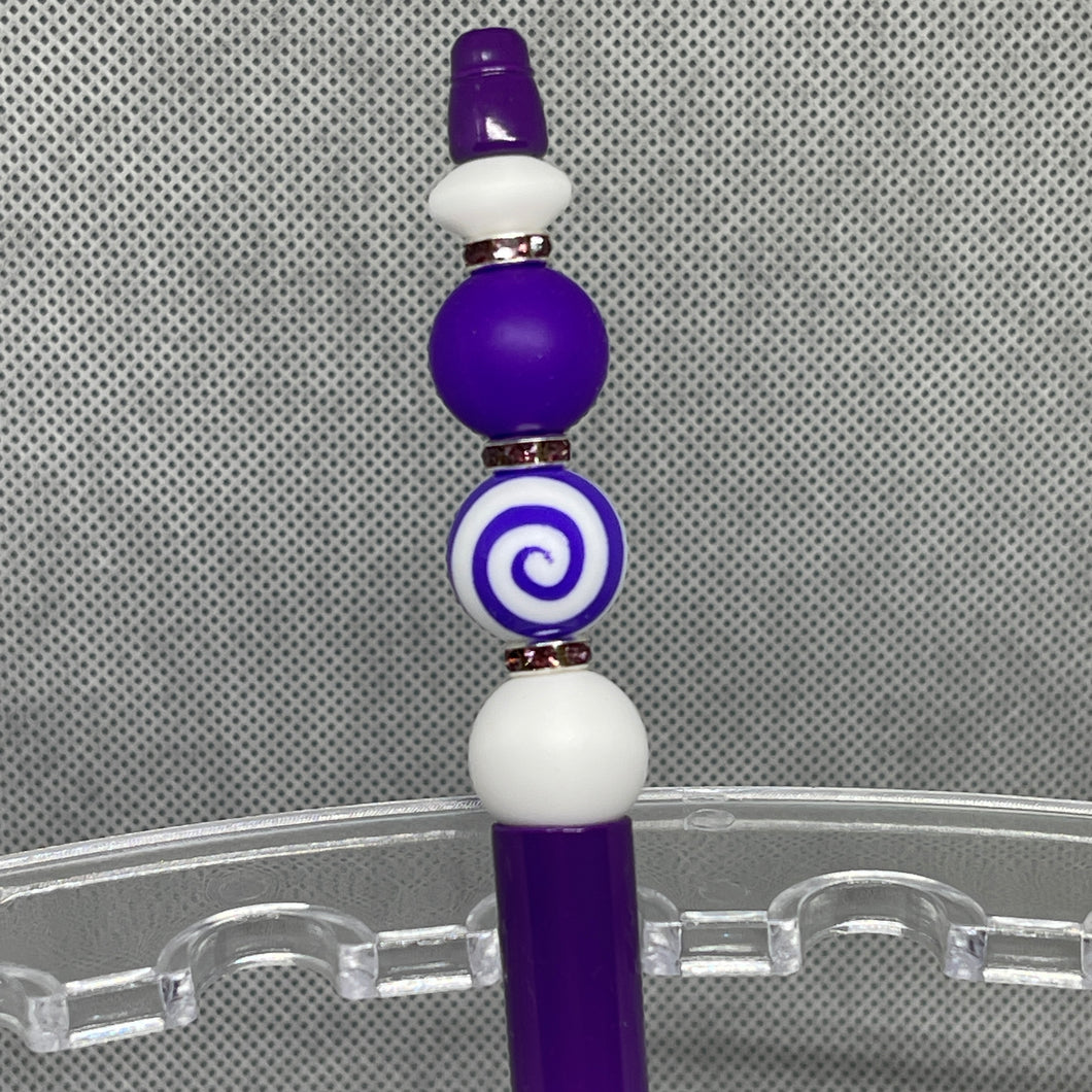 Purple and white beaded object on a clear stand with a gray textured background