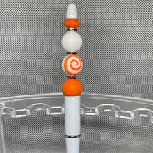 Load image into Gallery viewer, Decorative pen with orange and white beads on a metallic surface
