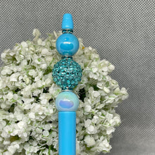 Load image into Gallery viewer, Blue decorative hair stick with beads on a floral background
